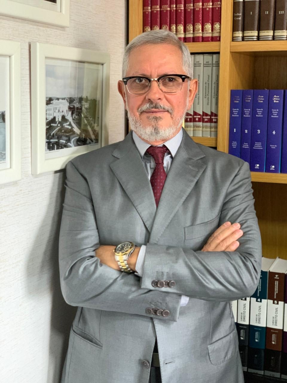 Retrato de Sérgio Lucio Ruffo, de terno cinza, gravata vinho e braços cruzados